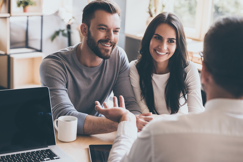 couple working with mortgage loan officer