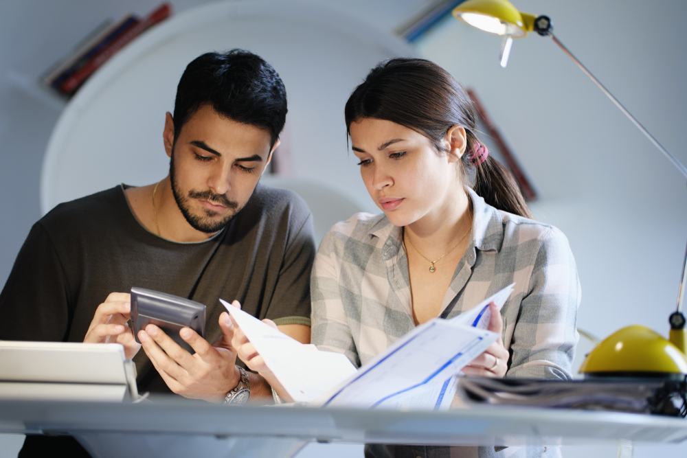 couple checking to see if they qualify for a mortgage